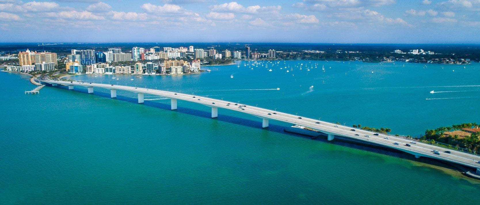 Aerial view of bridge and waterfront real estate in Sarasota, Florida